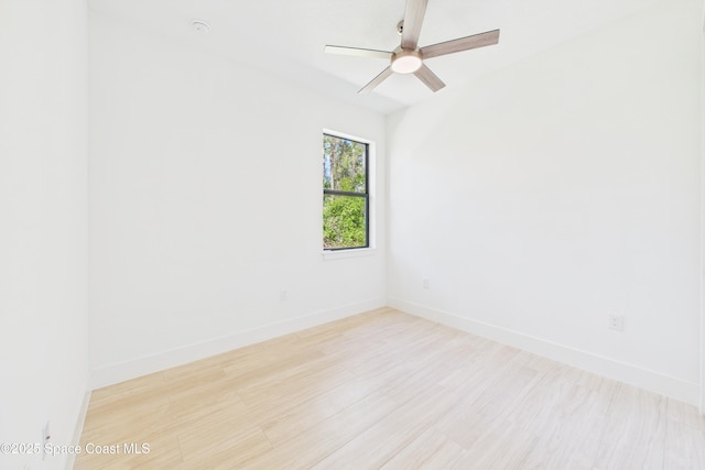 spare room featuring baseboards, a ceiling fan, and wood finished floors
