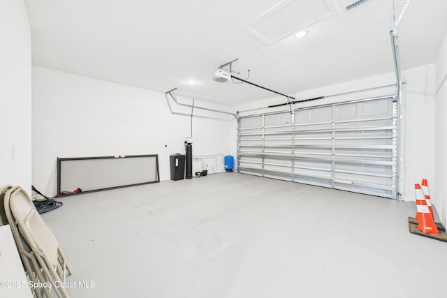 garage with recessed lighting and a garage door opener