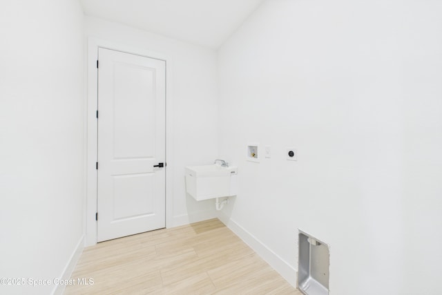laundry room with light wood-style flooring, baseboards, hookup for a washing machine, electric dryer hookup, and laundry area