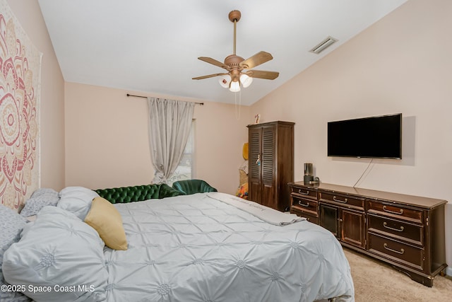 bedroom with light colored carpet, ceiling fan, lofted ceiling, and visible vents