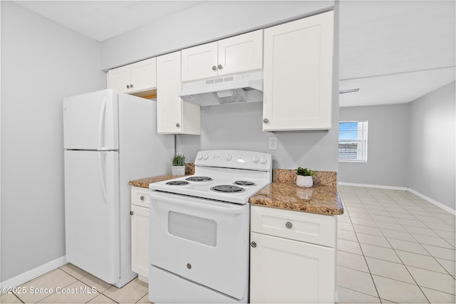 kitchen featuring white cabinetry, under cabinet range hood, light tile patterned floors, and white appliances