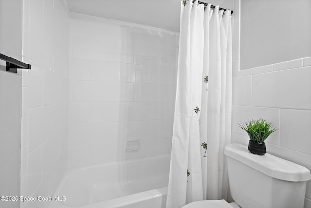 full bathroom with shower / tub combo, tile walls, and toilet
