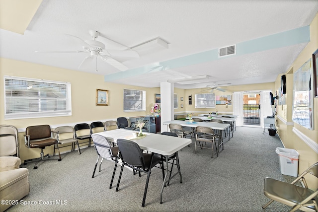 dining room featuring carpet floors, a ceiling fan, and visible vents