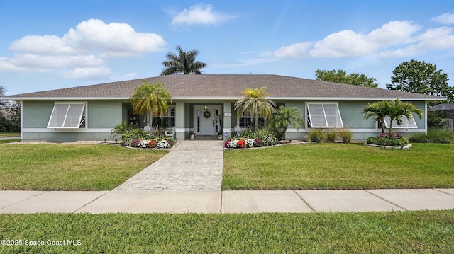 235 Northgrove Dr, Merritt Island, FL 32953 - single story home with a front yard, stucco siding, and covered porch