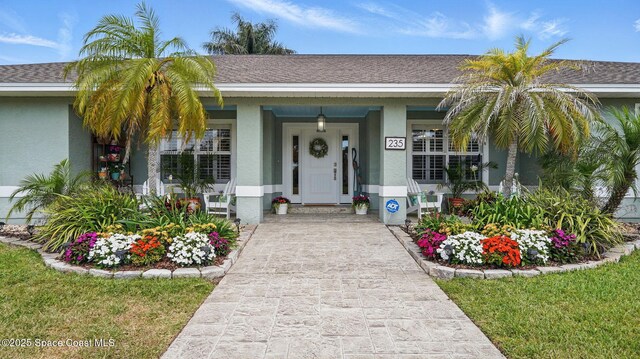 235 Northgrove Dr, Merritt Island, FL 32953 - view of front of home with stucco siding and covered porch