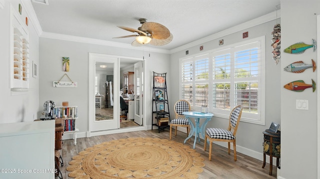 235 Northgrove Dr, Merritt Island, FL 32953 - living area featuring a ceiling fan, wood finished floors, baseboards, and ornamental molding