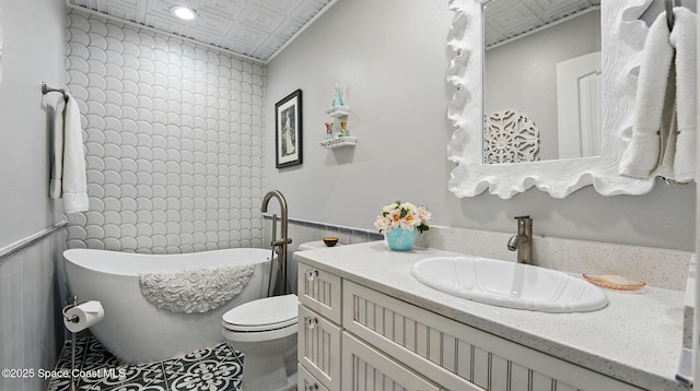 235 Northgrove Dr, Merritt Island, FL 32953 - full bath with a freestanding bath, vanity, wainscoting, and toilet