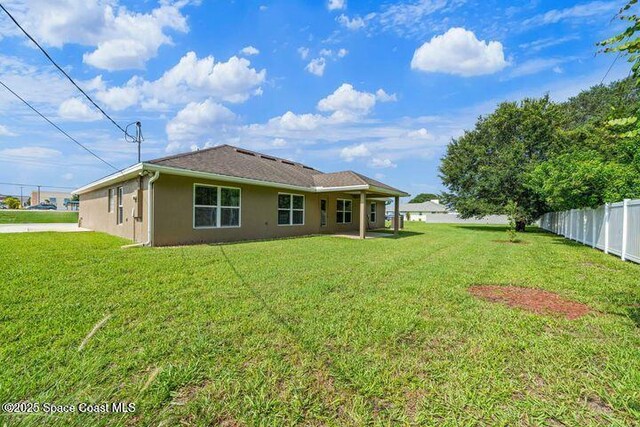 1830 San Filippo Dr SE, Palm Bay, FL 32909 - rear view of property with a yard, stucco siding, and fence