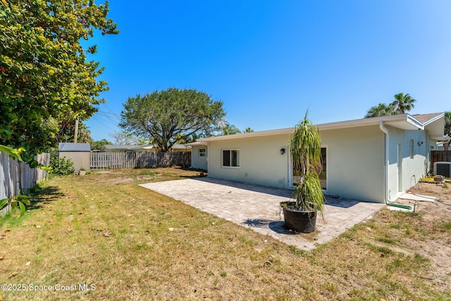 170 Maple Dr, Satellite Beach, FL 32937 - rear view of house with a patio area, a fenced backyard, a yard, and stucco siding