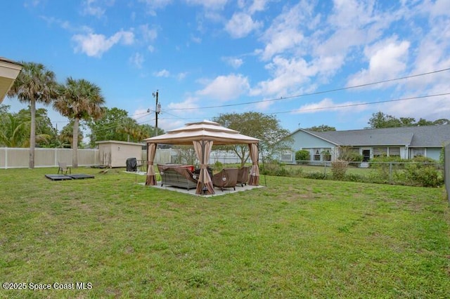 618 Americana Blvd NE, Palm Bay, FL 32907 - view of yard with a fenced backyard, a storage unit, a gazebo, and an outbuilding