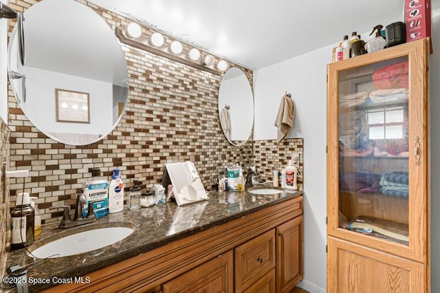 618 Americana Blvd NE, Palm Bay, FL 32907 - bathroom featuring a sink, double vanity, and tasteful backsplash