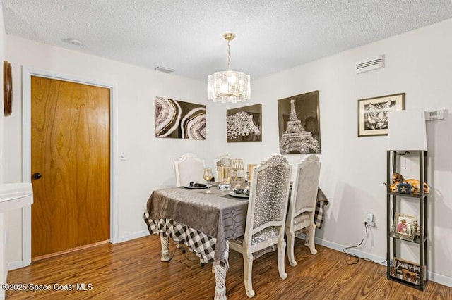 618 Americana Blvd NE, Palm Bay, FL 32907 - dining space with wood finished floors, a textured ceiling, baseboards, and a notable chandelier