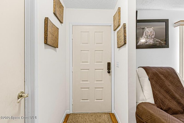 618 Americana Blvd NE, Palm Bay, FL 32907 - doorway featuring baseboards and a textured ceiling