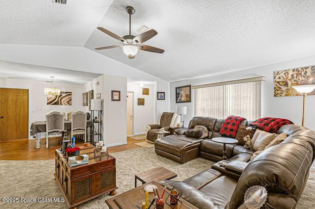 618 Americana Blvd NE, Palm Bay, FL 32907 - living area with ceiling fan with notable chandelier, light wood-style flooring, a textured ceiling, and vaulted ceiling