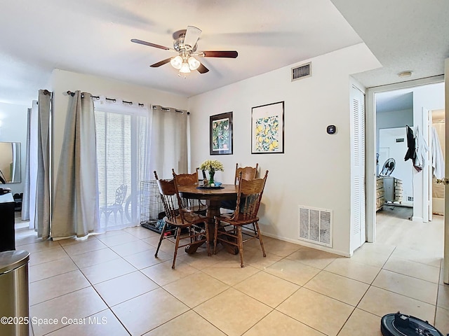 dining area featuring visible vents, ceiling fan, light tile patterned flooring, and baseboards