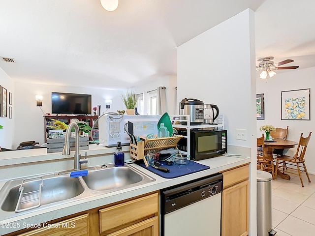 kitchen with light tile patterned floors, black microwave, visible vents, a sink, and white dishwasher