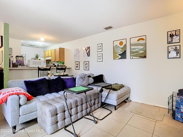 living area with light tile patterned flooring and visible vents