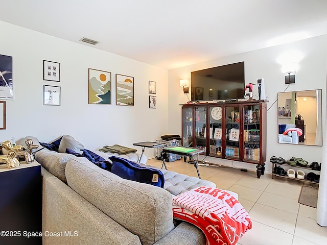 living area featuring tile patterned floors and visible vents