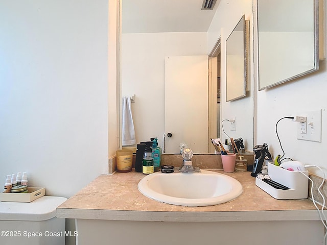 bathroom featuring visible vents and vanity