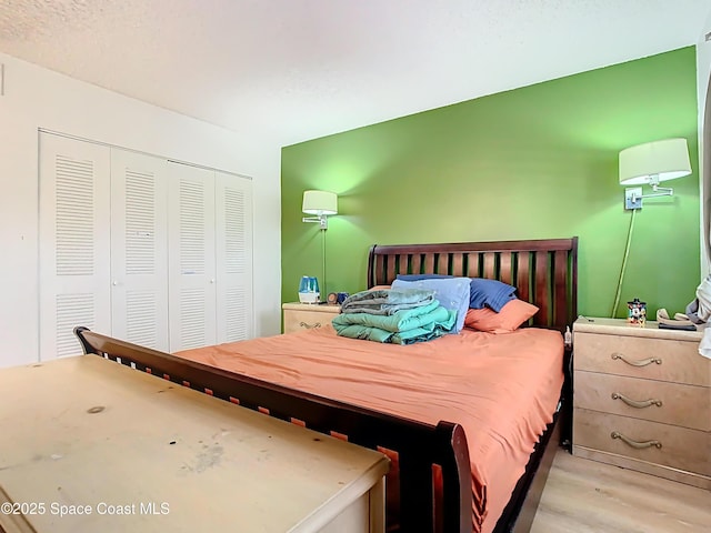 bedroom featuring a closet and light wood finished floors
