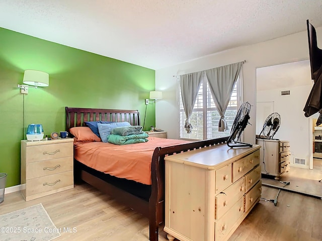 bedroom featuring visible vents and light wood-type flooring