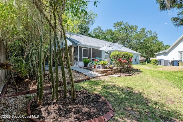 view of yard with fence and a sunroom