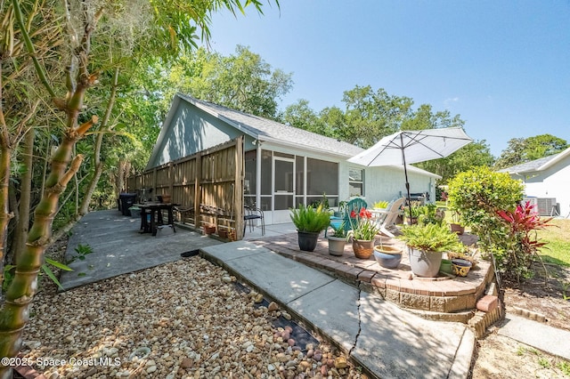 back of property with a patio area, central AC, and a sunroom