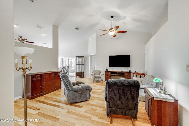 living area featuring light wood-type flooring, high vaulted ceiling, ceiling fan, and visible vents