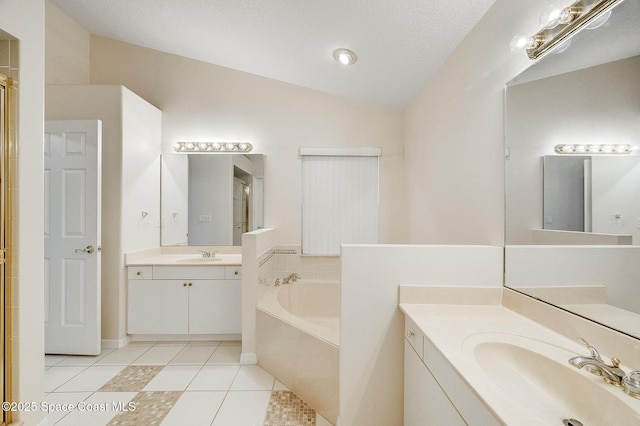 full bathroom featuring a sink, a bath, tile patterned flooring, and lofted ceiling