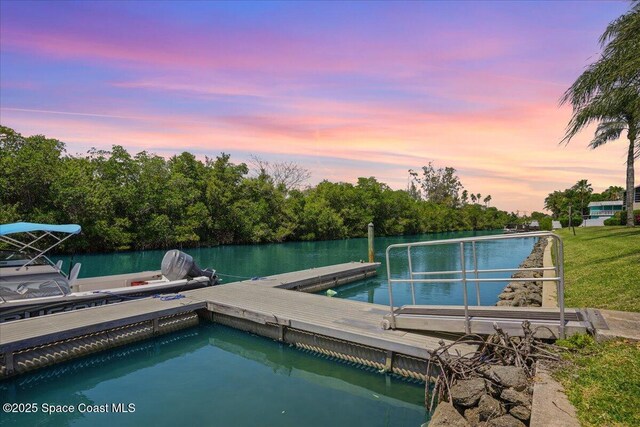 1845 Robalo Dr Unit 201D, Vero Beach, FL 32960 - pool at dusk featuring a floating dock and a water view