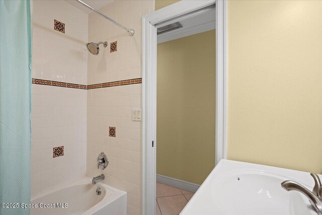 1845 Robalo Dr Unit 201D, Vero Beach, FL 32960 - full bathroom featuring shower / bath combination with curtain, baseboards, tile patterned floors, and a sink
