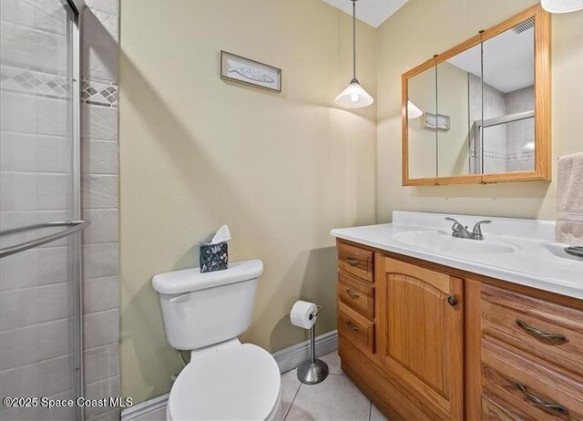 1845 Robalo Dr Unit 201D, Vero Beach, FL 32960 - full bathroom featuring tiled shower, toilet, baseboards, tile patterned flooring, and vanity
