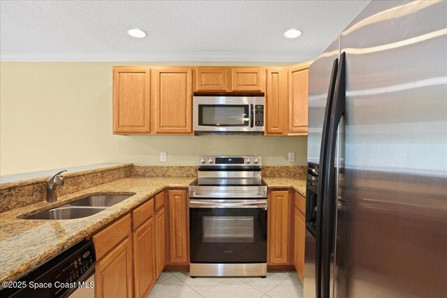 1845 Robalo Dr Unit 201D, Vero Beach, FL 32960 - kitchen with stainless steel appliances, a sink, light stone counters, and light tile patterned flooring