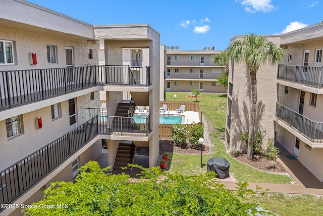 3150 N Harbor City Blvd Unit 341, Melbourne, FL 32935 - view of building exterior featuring a community pool and stairway