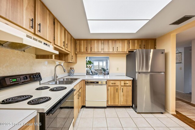 3150 N Harbor City Blvd Unit 341, Melbourne, FL 32935 - kitchen with a sink, under cabinet range hood, range with electric cooktop, visible vents, and freestanding refrigerator