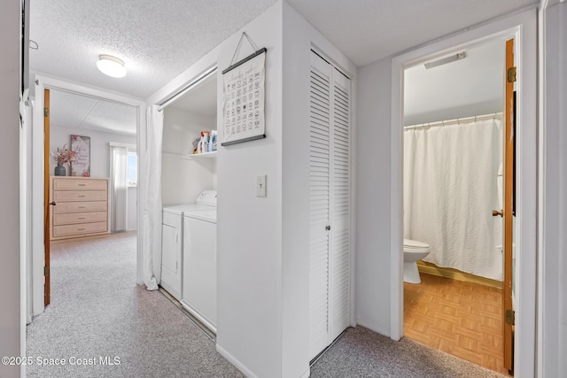 3150 N Harbor City Blvd Unit 341, Melbourne, FL 32935 - hall featuring a textured ceiling, visible vents, and separate washer and dryer