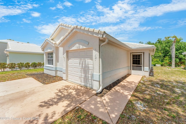 1157 Goldenrod Cir NE, Palm Bay, FL 32905 - view of property exterior featuring stucco siding, a tile roof, and a garage