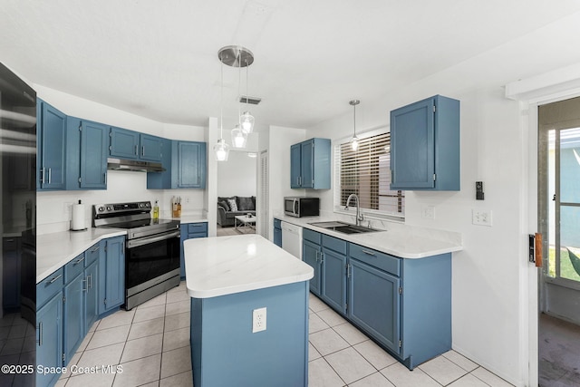 1157 Goldenrod Cir NE, Palm Bay, FL 32905 - kitchen featuring blue cabinetry, stainless steel appliances, under cabinet range hood, a kitchen island, and a sink