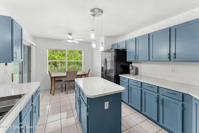 1157 Goldenrod Cir NE, Palm Bay, FL 32905 - kitchen featuring blue cabinetry, stainless steel fridge, light countertops, a center island, and pendant lighting
