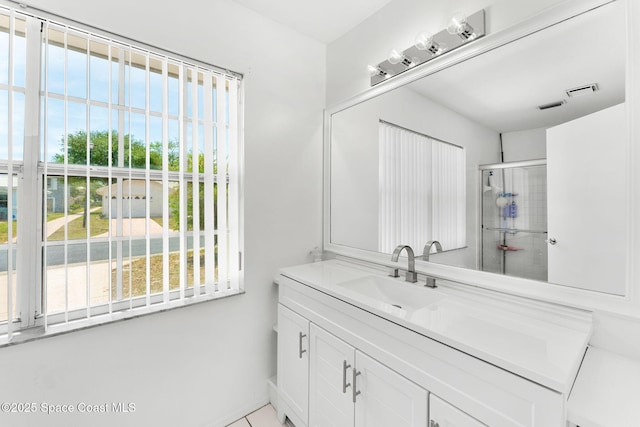 1157 Goldenrod Cir NE, Palm Bay, FL 32905 - bathroom featuring visible vents, a shower with door, and vanity