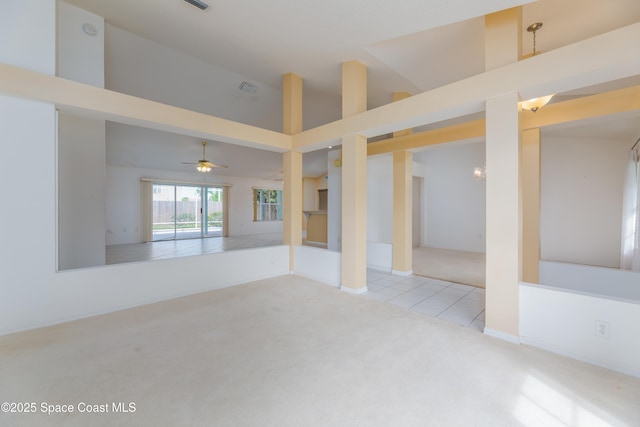 1872 Crane Creek Blvd, Melbourne, FL 32940 - unfurnished living room featuring tile patterned floors, carpet, a ceiling fan, and high vaulted ceiling