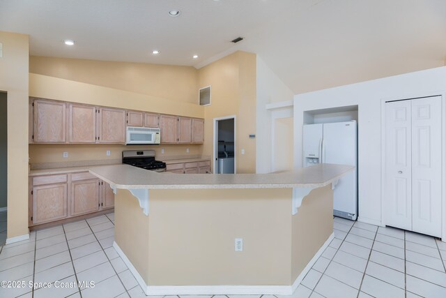 1872 Crane Creek Blvd, Melbourne, FL 32940 - kitchen with a center island, light tile patterned floors, light countertops, light brown cabinets, and white appliances