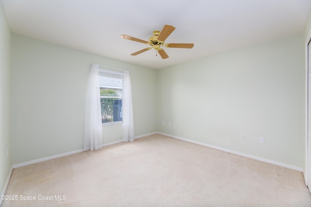 1872 Crane Creek Blvd, Melbourne, FL 32940 - spare room featuring baseboards, a ceiling fan, and light colored carpet