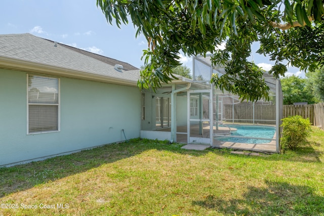 1872 Crane Creek Blvd, Melbourne, FL 32940 - rear view of property with a lawn, fence, a shingled roof, and a fenced in pool