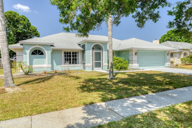 1872 Crane Creek Blvd, Melbourne, FL 32940 - single story home featuring an attached garage, driveway, stucco siding, and a front yard