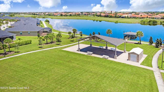 drone / aerial view featuring a residential view and a water view