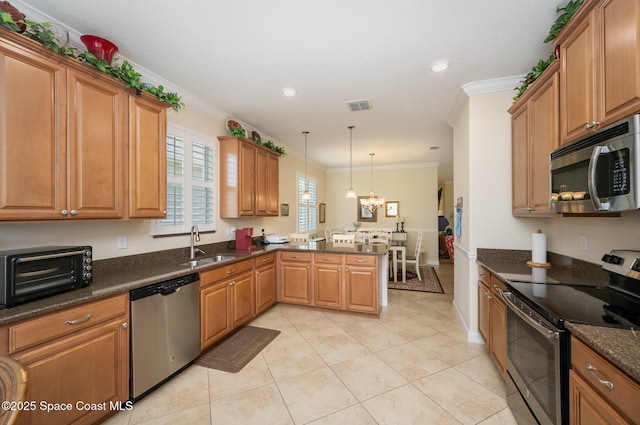 kitchen with stainless steel appliances, a peninsula, a sink, a toaster, and visible vents