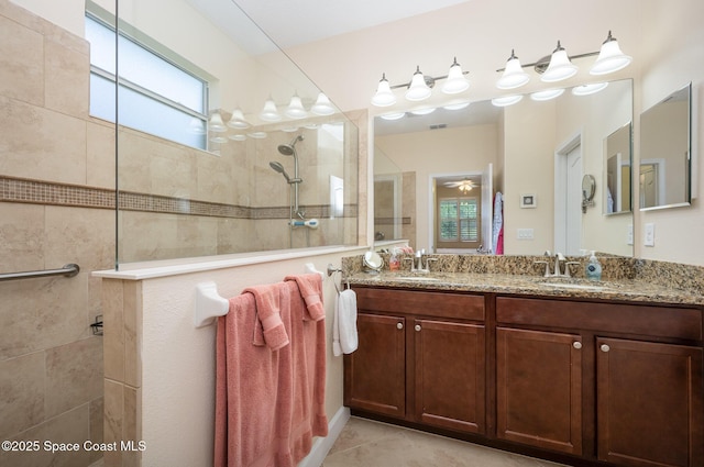 full bath featuring walk in shower, visible vents, a sink, and double vanity