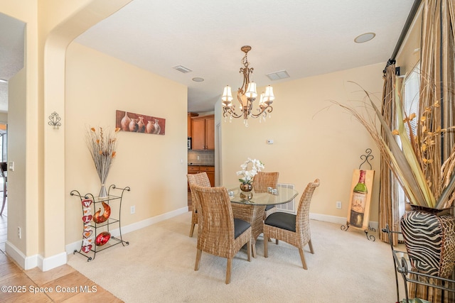 1472 Bent Palm Dr, Merritt Island, FL 32952 - dining area with a chandelier, light carpet, and plenty of natural light