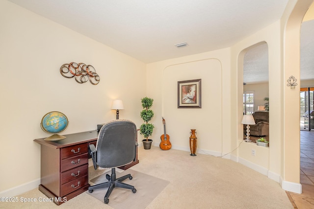 1472 Bent Palm Dr, Merritt Island, FL 32952 - office area with arched walkways, light carpet, and baseboards